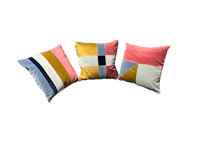 three colorful pillows on a black background