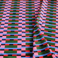 a close up of a pink, green, and blue fabric